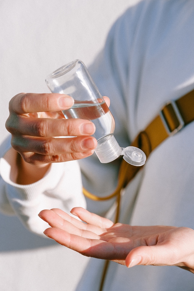 person-in-white-long-sleeve-shirt-holding-clear-bottle-3962516