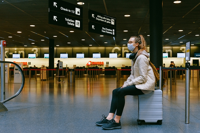 woman-sitting-on-luggage-3943882